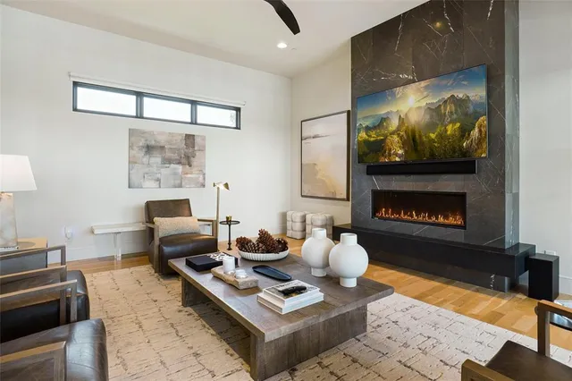 a living room with furniture a rug and a fireplace
