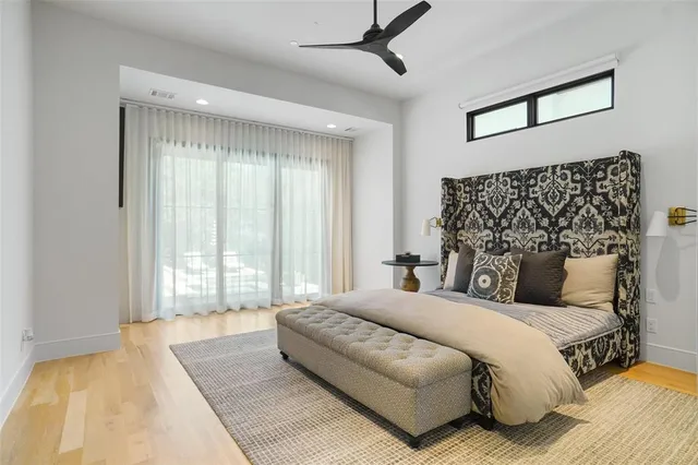 a spacious bedroom with a large bed and a window