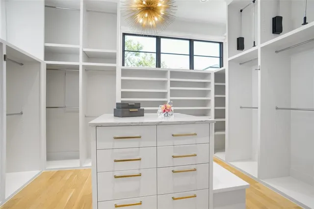a view of walk in closet with empty racks