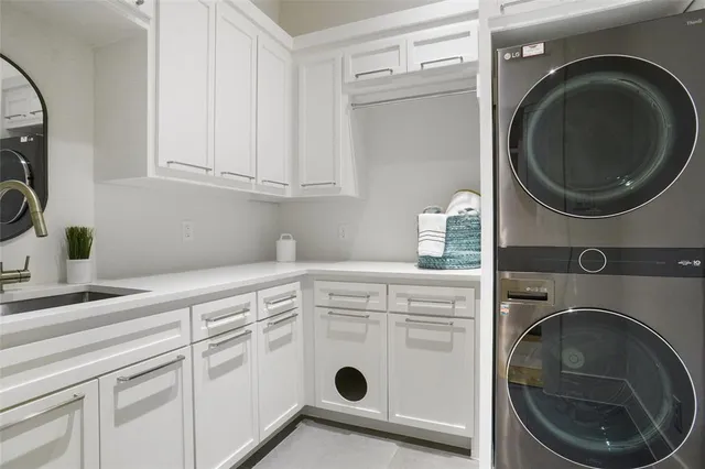 a utility room with sink dryer and washer
