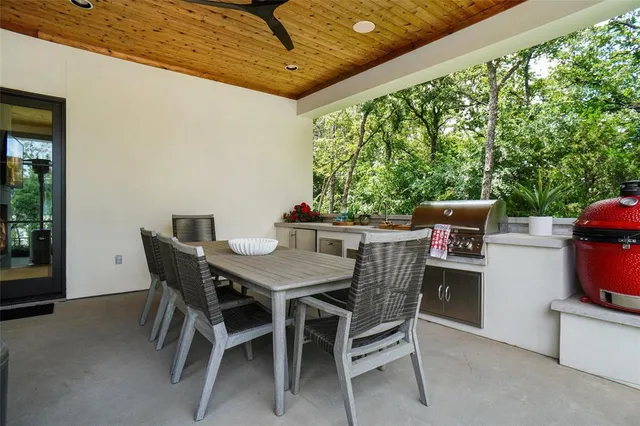 a view of an outdoor dining space with a table and chairs
