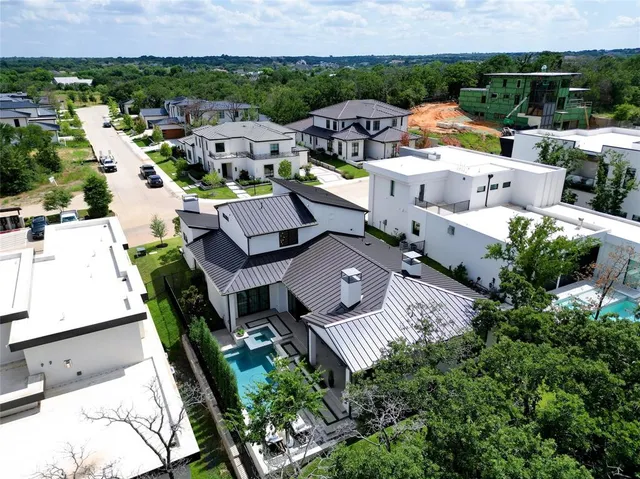 an aerial view of multiple houses with a yard