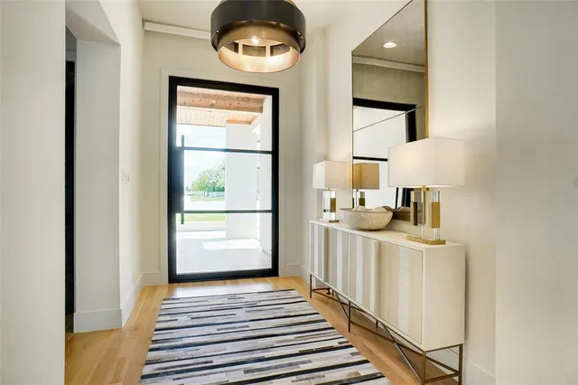 a view of a hallway to a livingroom with furniture