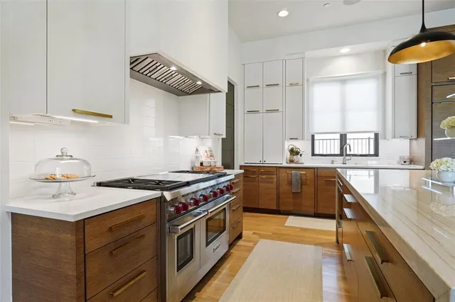 a kitchen with stainless steel appliances granite countertop a stove and a sink