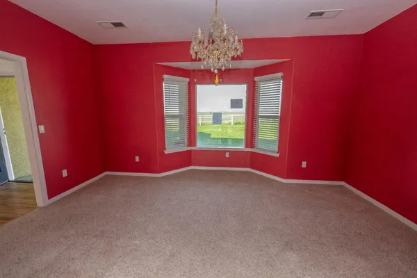 a view of empty room with wooden floor and fireplace