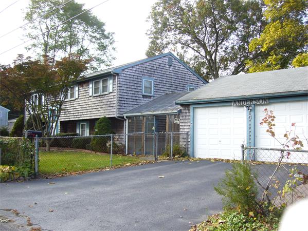 4 North Shore Road Holbrook, MA 02343 - Photo 1 of 24 a front view of a house with a garden and garage