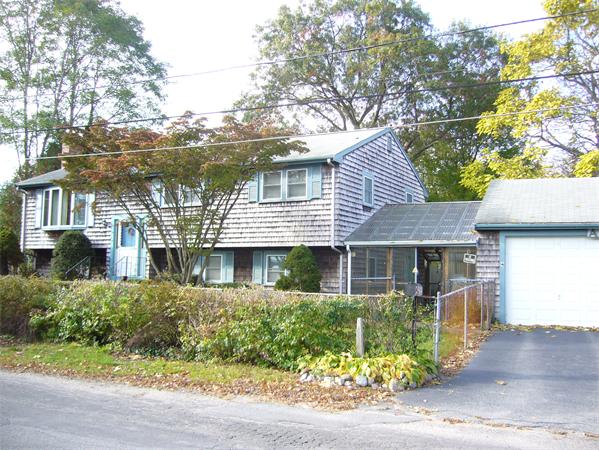 4 North Shore Road Holbrook, MA 02343 - Photo 3 of 24 a front view of a house with a garden and plants