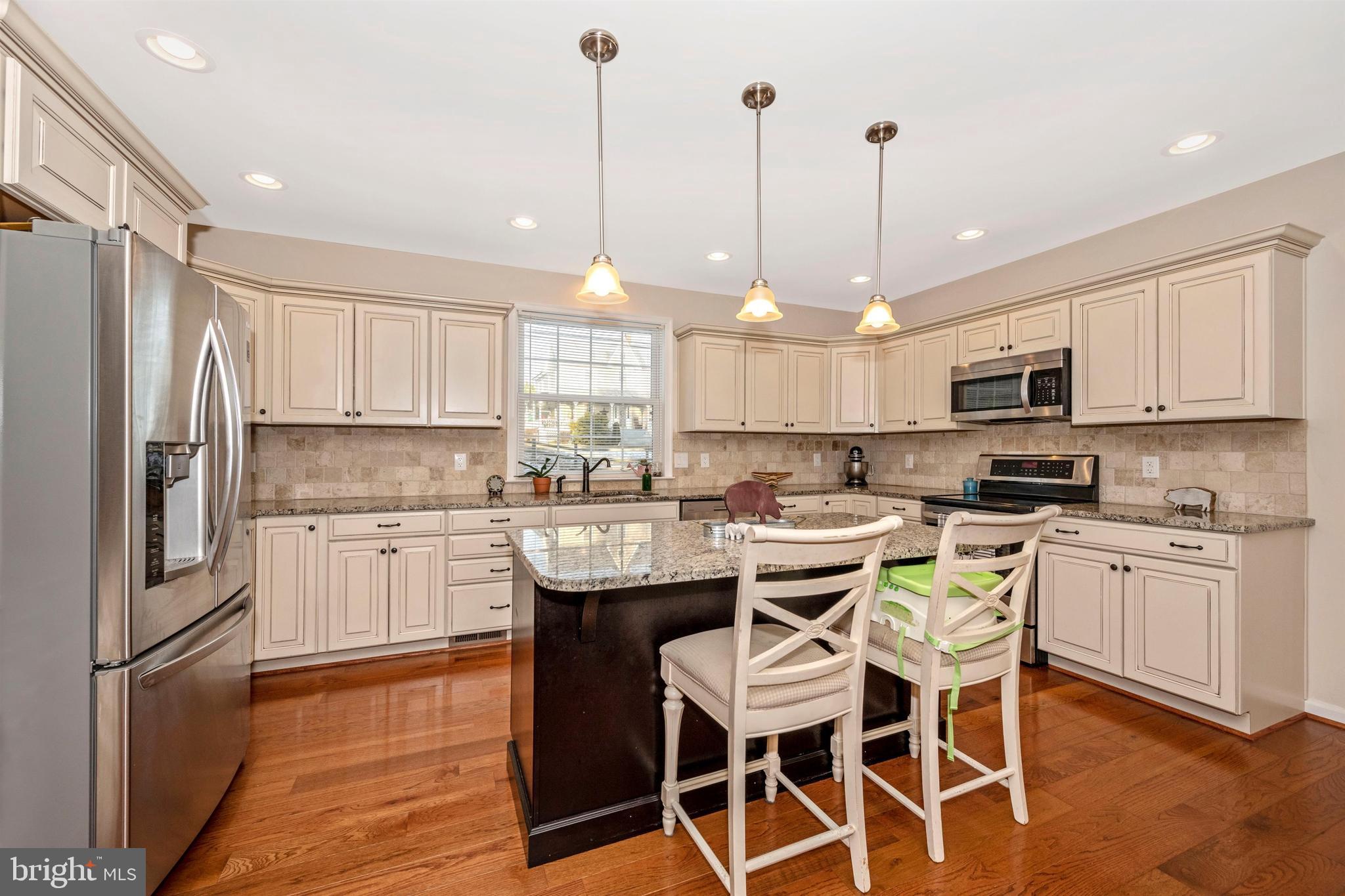 12529 Fingerboard Road Monrovia, MD 21770 - Photo 13 of 55 a kitchen with stainless steel appliances granite countertop a sink a stove a refrigerator cabinets and chairs