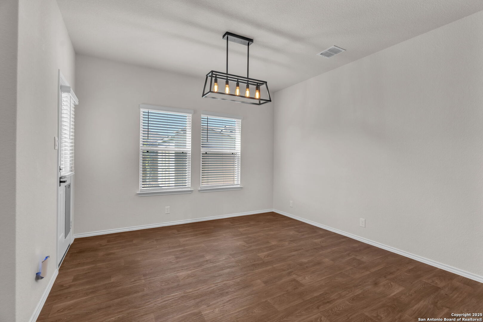 105 Honors Street Floresville, TX 78114 - Photo 13 of 36 a view of a room with wooden floor cabinet and windows