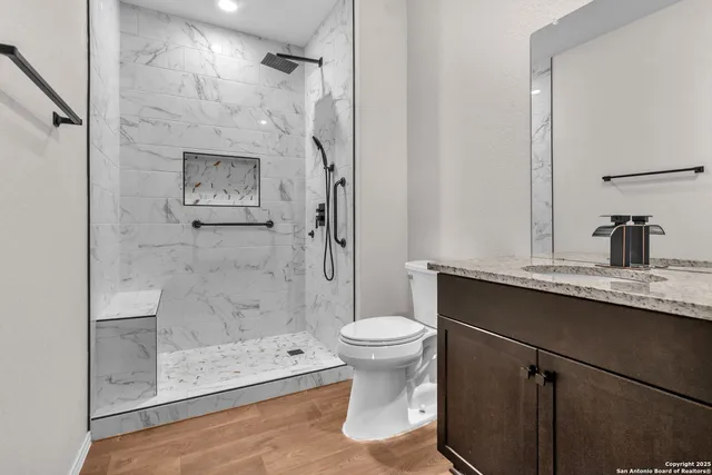 a bathroom with a sink toilet and shower