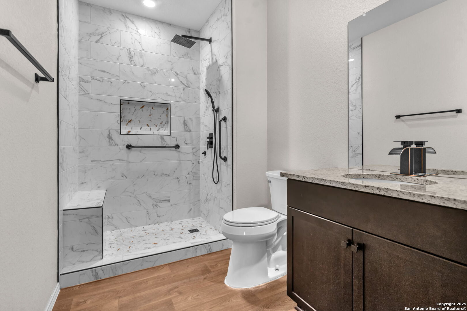 105 Honors Street Floresville, TX 78114 - Photo 15 of 36 a bathroom with a sink toilet and shower