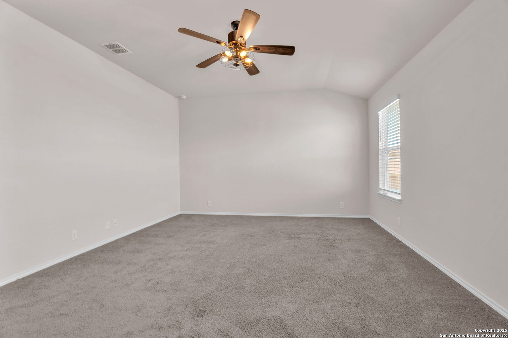 105 Honors Street Floresville, TX 78114 - Photo 18 of 36 an empty room with a window and a ceiling fan