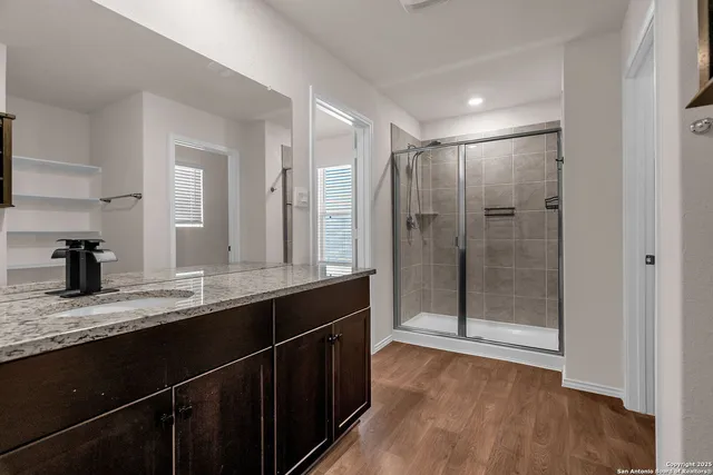 a bathroom with a granite countertop sink mirror and double