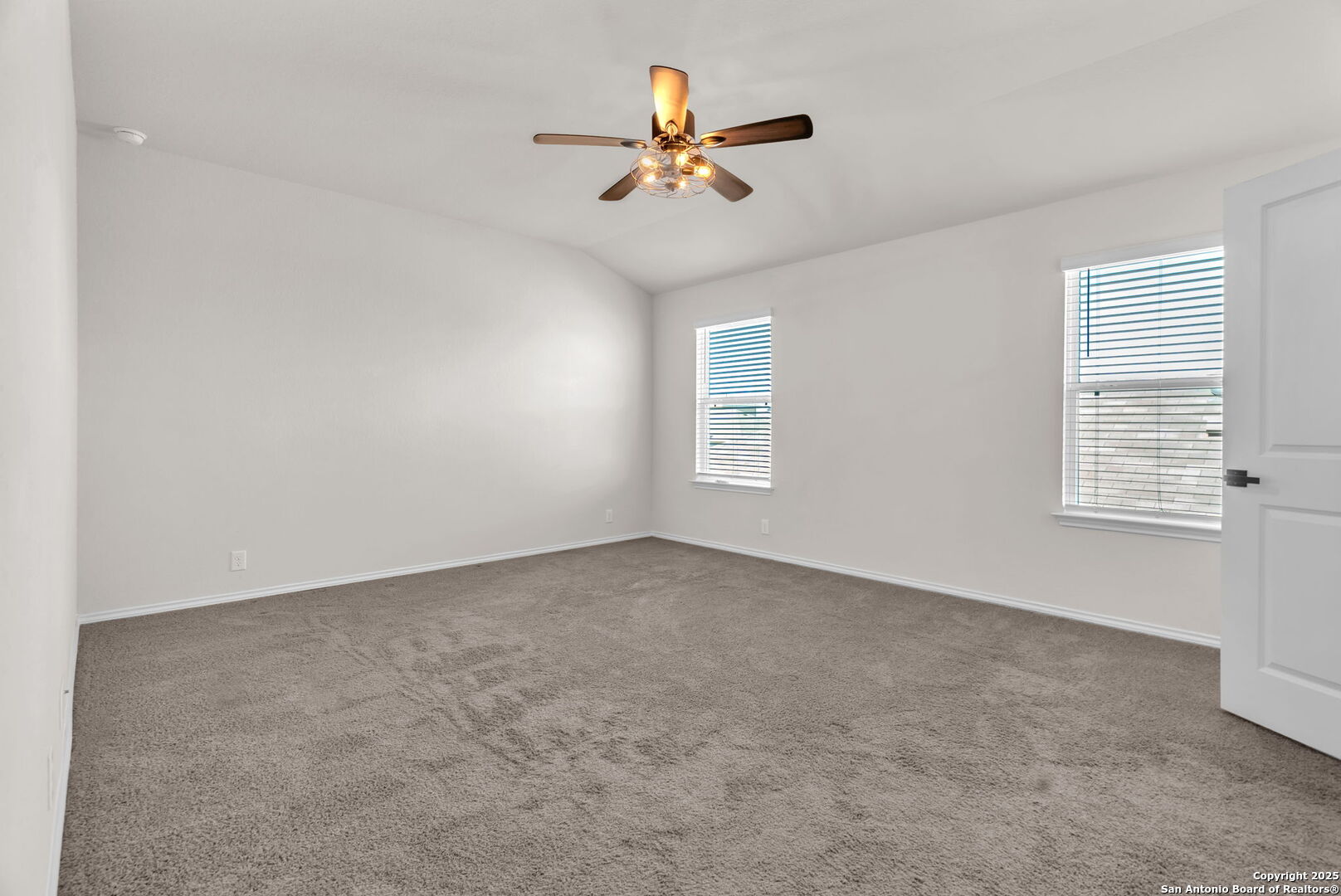 105 Honors Street Floresville, TX 78114 - Photo 25 of 36 an empty room with windows and fan