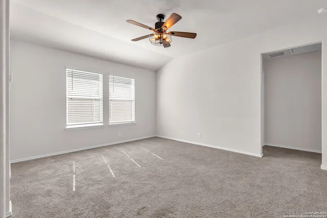 a view of an empty room with a window