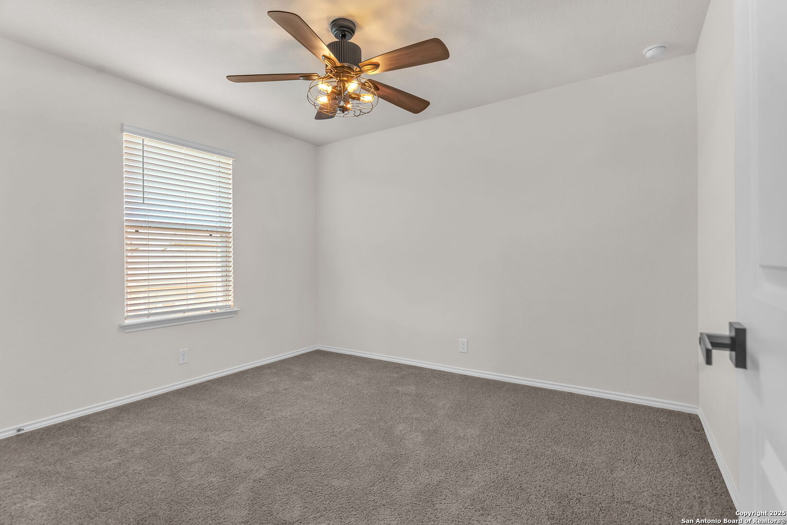 105 Honors Street Floresville, TX 78114 - Photo 30 of 36 an empty room with a window and a fan