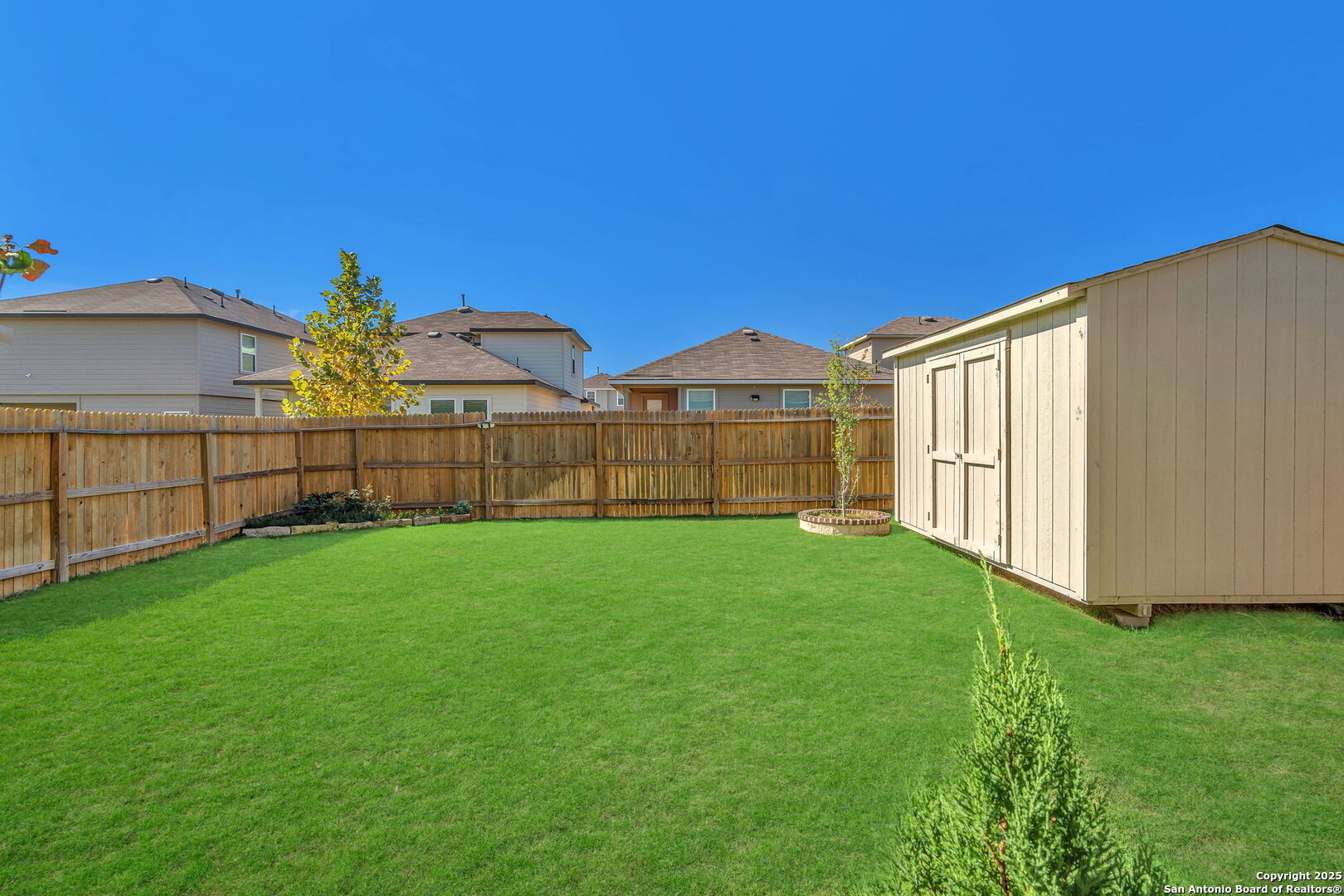 105 Honors Street Floresville, TX 78114 - Photo 34 of 36 a view of a yard with wooden fence