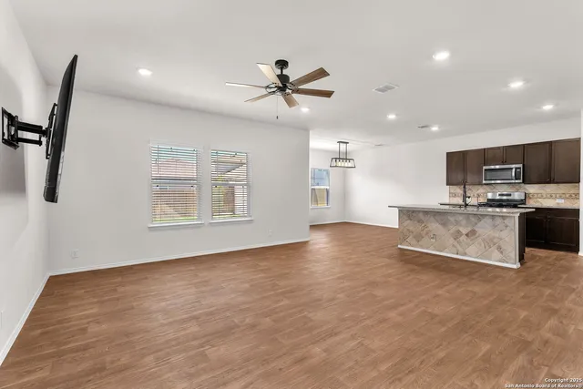 a view of kitchen with cabinets and wooden floor