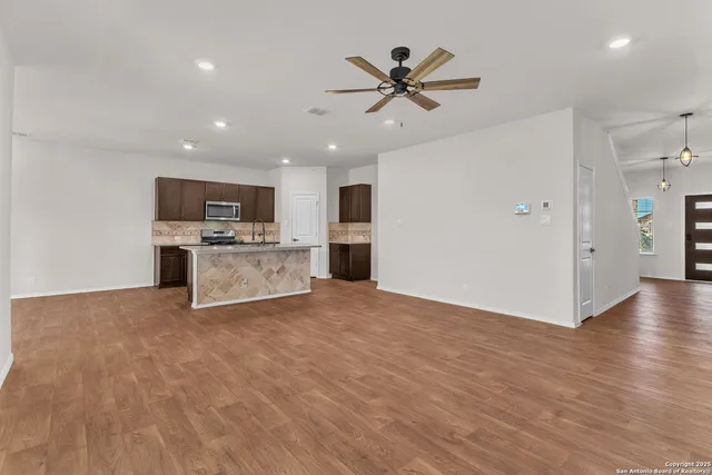 a view of a kitchen with a sink and a microwave