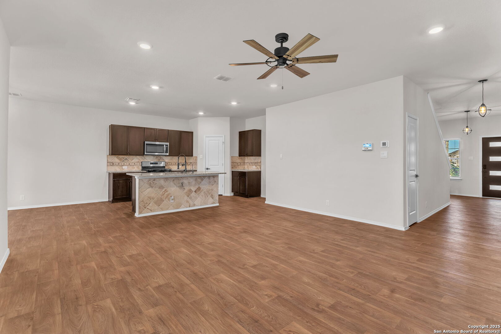 105 Honors Street Floresville, TX 78114 - Photo 9 of 36 a view of a kitchen with a sink and a microwave