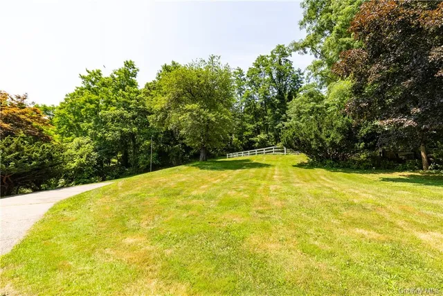 a swimming pool with trees in the background