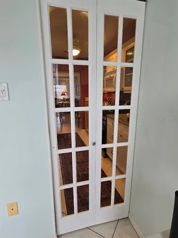 a living room with furniture a rug and white walls