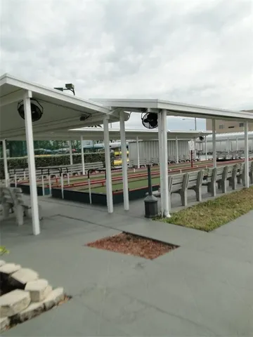 a view of a house with pool and chairs