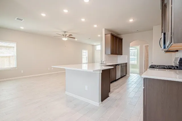 a view of kitchen with center island and stainless steel appliances
