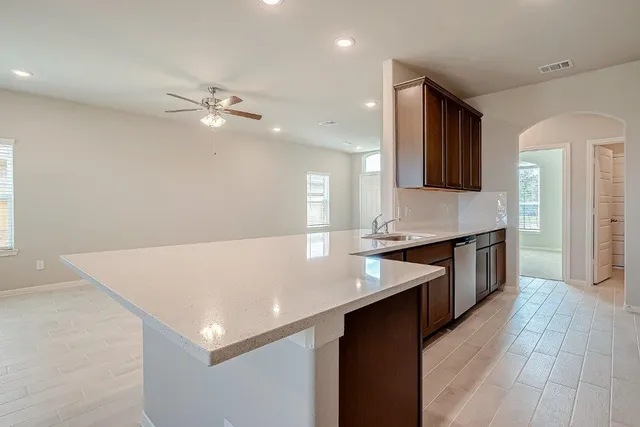 a kitchen with stainless steel appliances granite countertop a stove and a sink