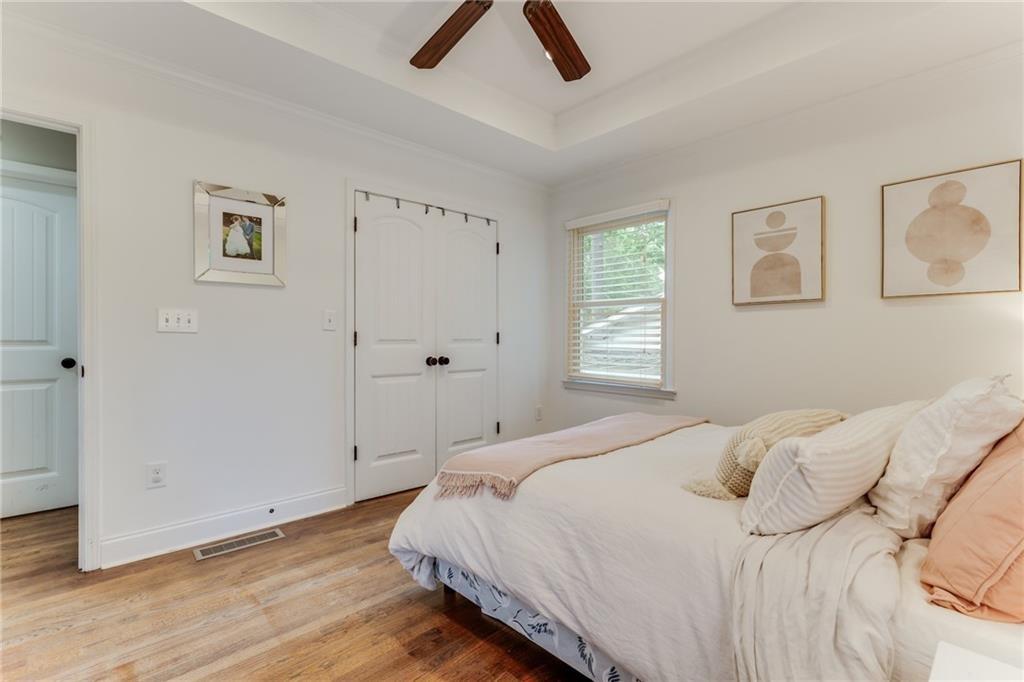 2357 Cortez Way Northeast Brookhaven, GA 30319 - Photo 18 of 32 a bedroom with a bed and a painting on the wall