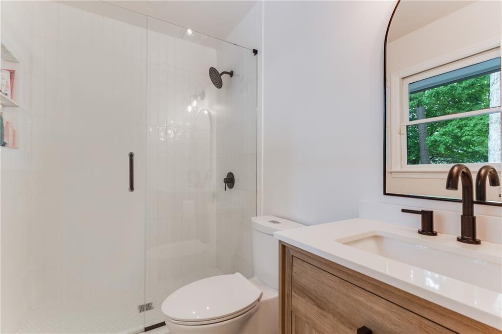 2357 Cortez Way Northeast Brookhaven, GA 30319 - Photo 19 of 32 a bathroom with a sink a toilet and shower