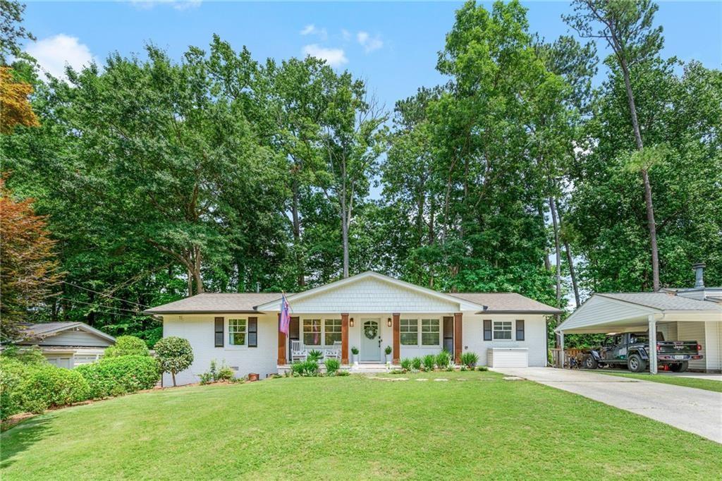 2357 Cortez Way Northeast Brookhaven, GA 30319 - Photo 2 of 32 a front view of a house with a garden and trees