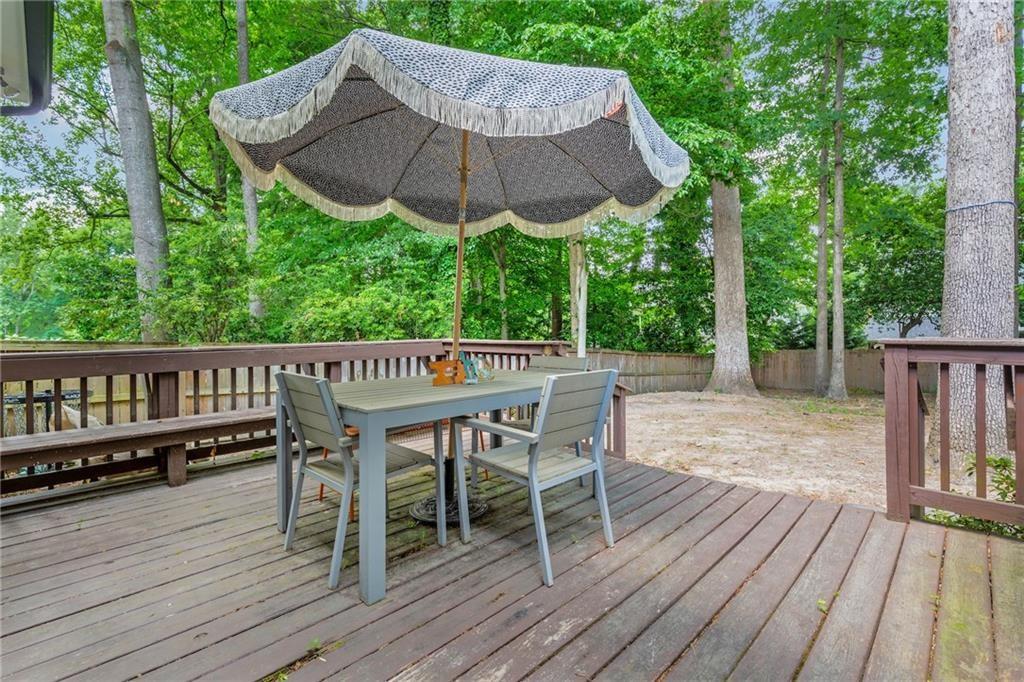 2357 Cortez Way Northeast Brookhaven, GA 30319 - Photo 28 of 32 a patio with wooden floor a yard a table and chairs