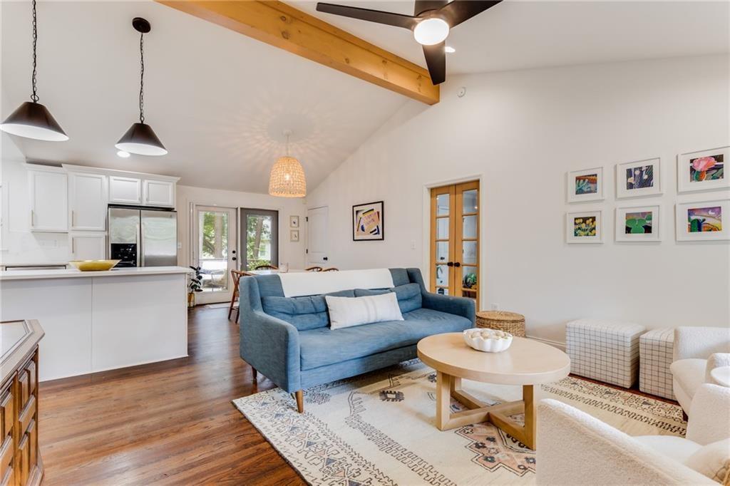2357 Cortez Way Northeast Brookhaven, GA 30319 - Photo 6 of 32 a living room with furniture a rug and kitchen view