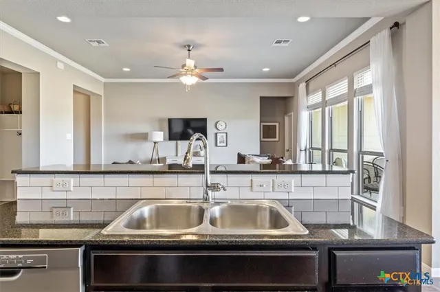 a kitchen with a sink and a refrigerator