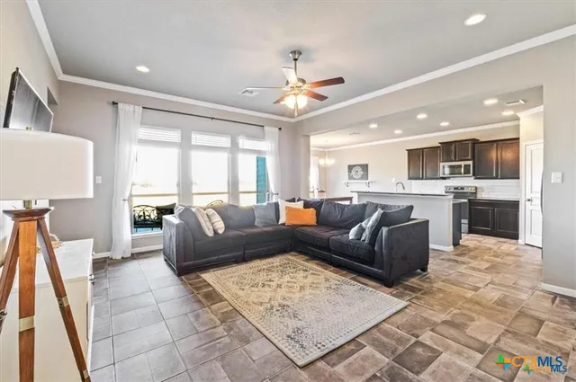 a living room with furniture and a large window