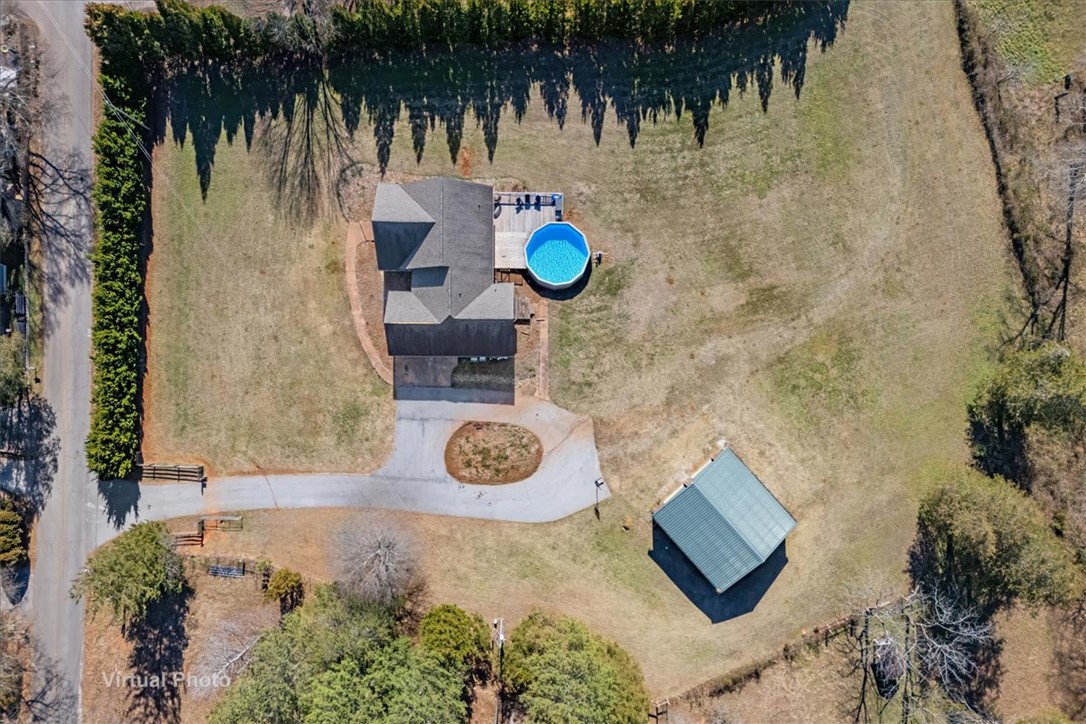 212 Winding Lane Seneca, SC 29672 - Photo 46 of 47 An aerial view captures a serene property featuring a private pool and outbuilding amidst expansive grounds.
