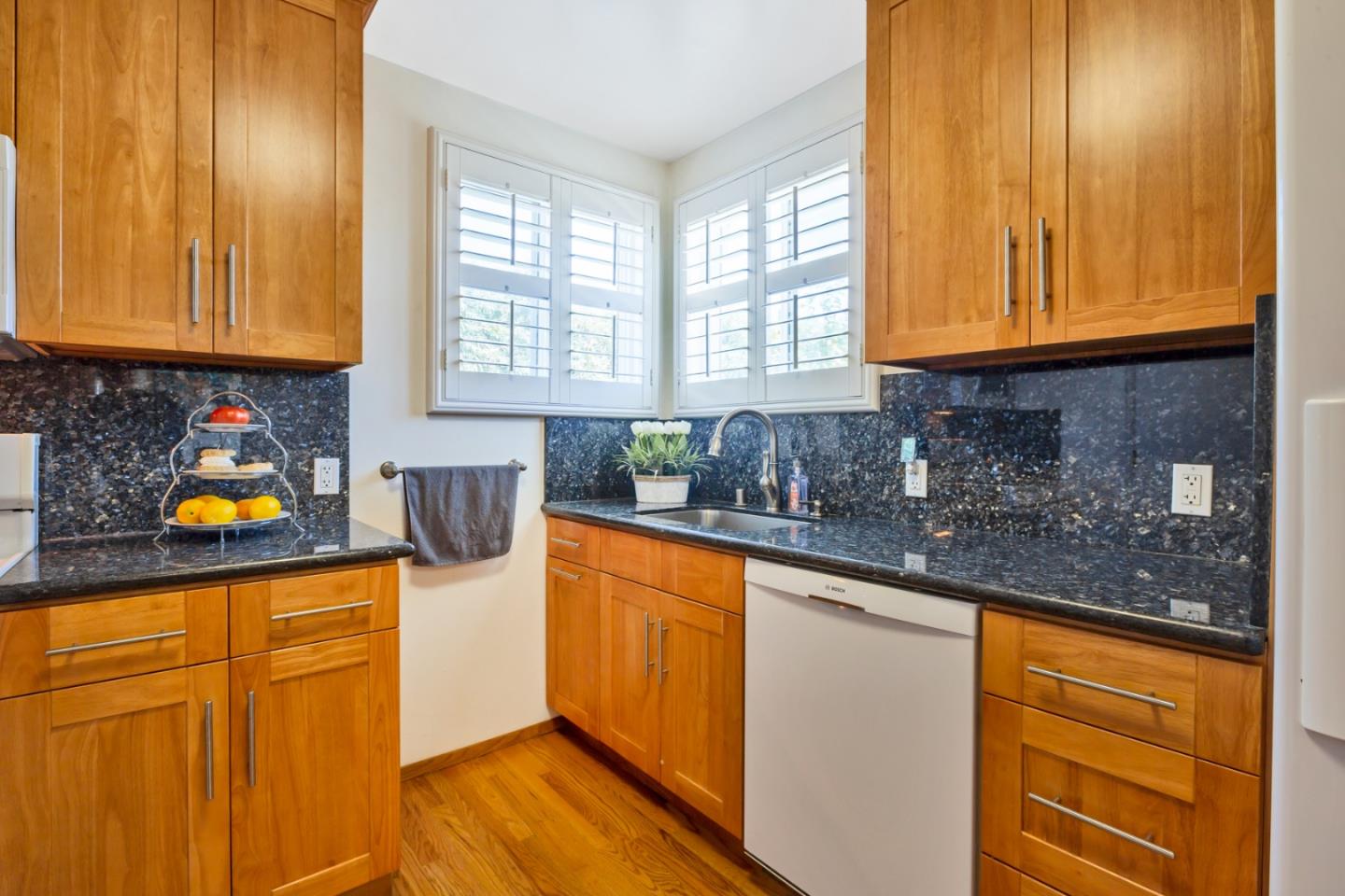 16 North Rochester Street San Mateo, CA 94401 - Photo 17 of 27 a kitchen with stainless steel appliances granite countertop wooden cabinets a sink and dishwasher with wooden floor