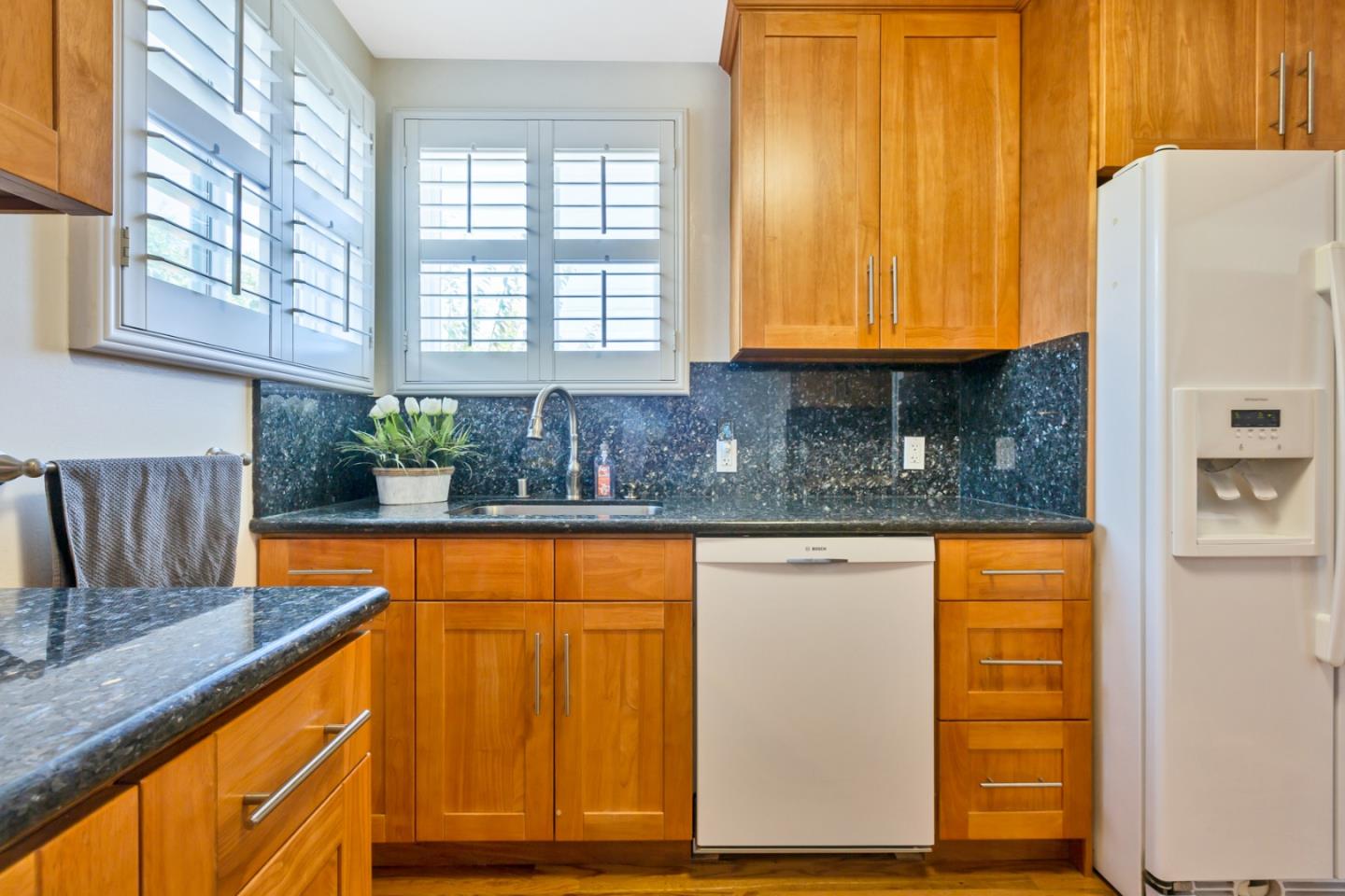 16 North Rochester Street San Mateo, CA 94401 - Photo 18 of 27 a kitchen with stainless steel appliances granite countertop wooden floor sink and window