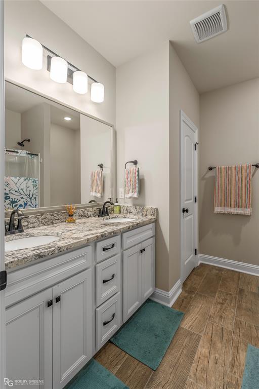 122 Brimestone Loop Benton, LA 71006 - Photo 25 of 33 a bathroom with a granite countertop sink and a mirror