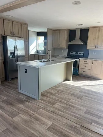 a kitchen with stainless steel appliances granite countertop a sink stove and refrigerator