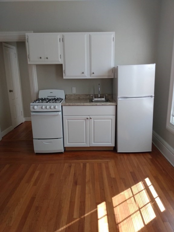 107-121 Winter Street Fall River, MA 02720 - Photo 5 of 10 a kitchen with a white cabinets and white appliances