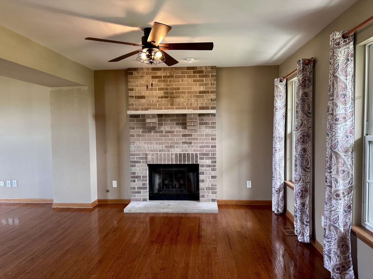 811 Water Stone Way Malta, IL 60150 - Photo 14 of 27 a view of an empty room with wooden floor fireplace and a window