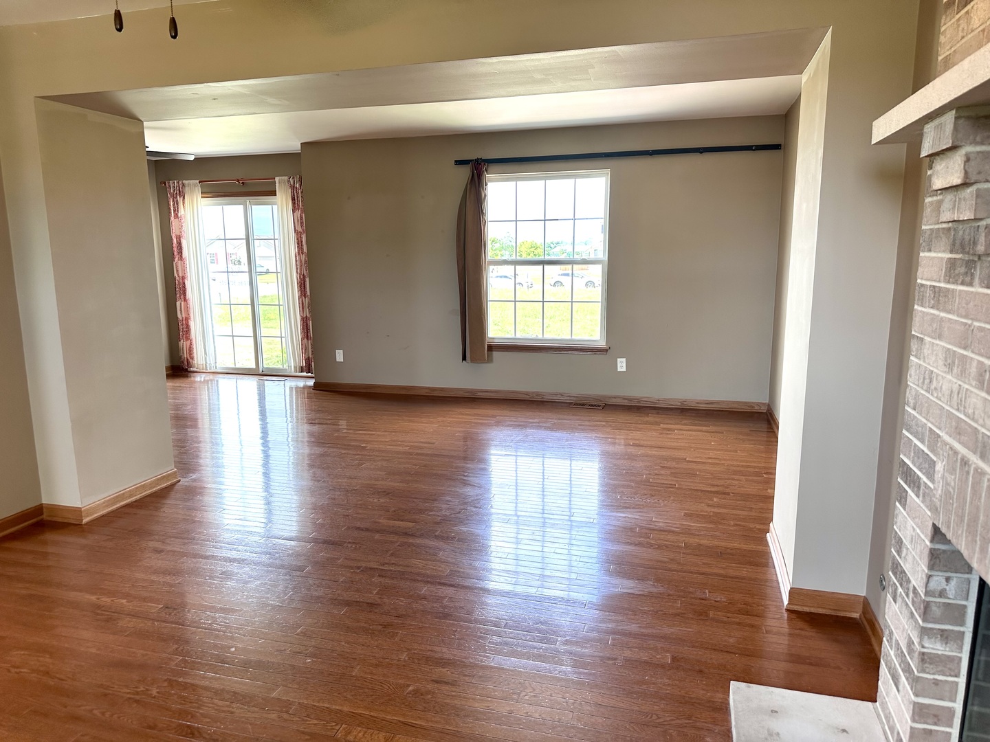 811 Water Stone Way Malta, IL 60150 - Photo 15 of 27 a view of an empty room with wooden floor and a window