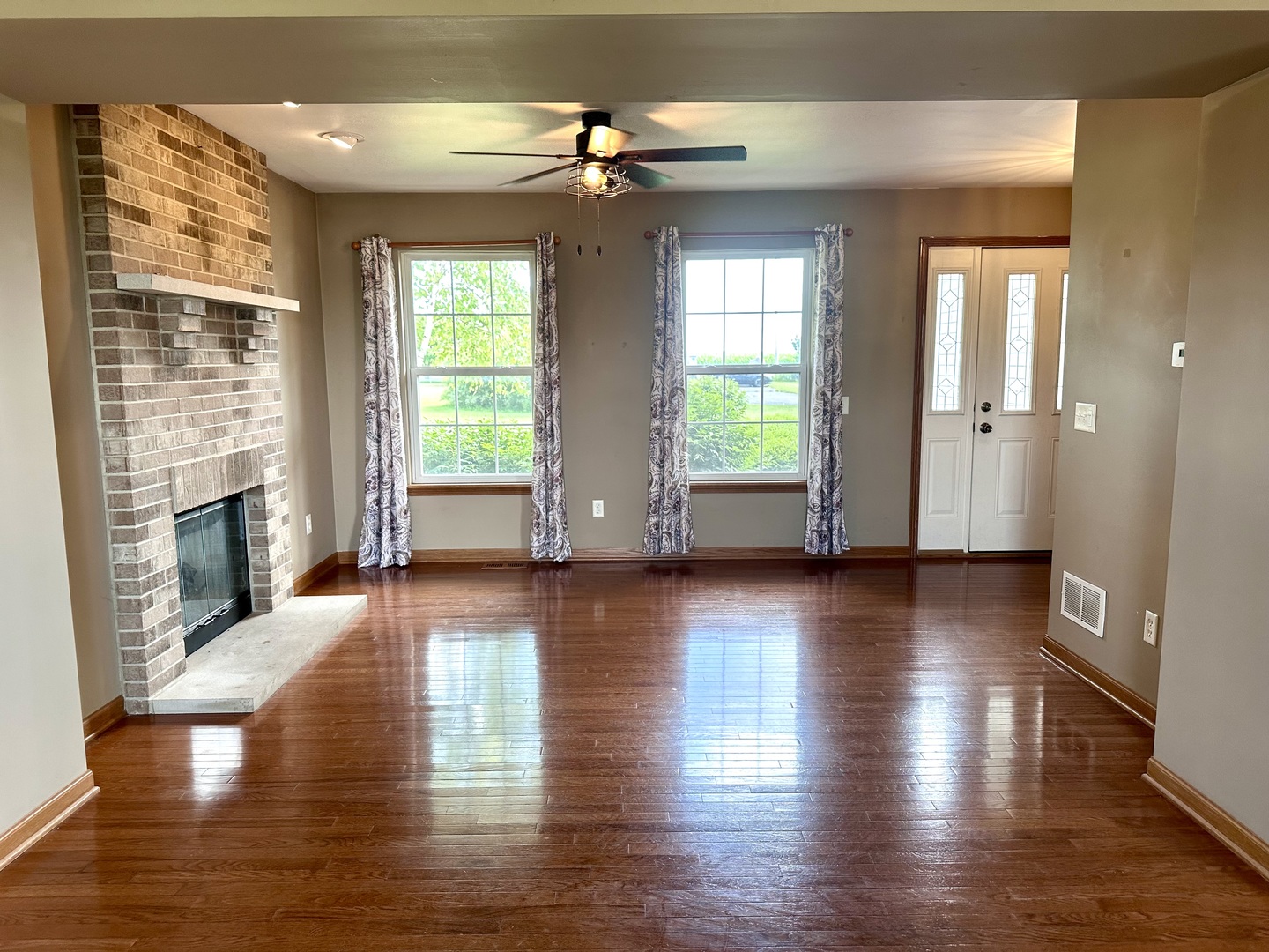 811 Water Stone Way Malta, IL 60150 - Photo 3 of 27 an empty room with wooden floor and windows