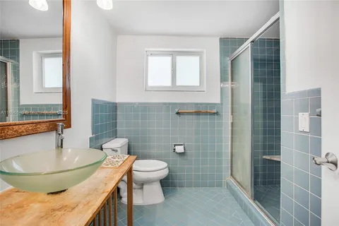 a bathroom with a sink toilet and shower