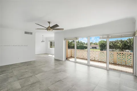 a view of a livingroom with a ceiling fan and window