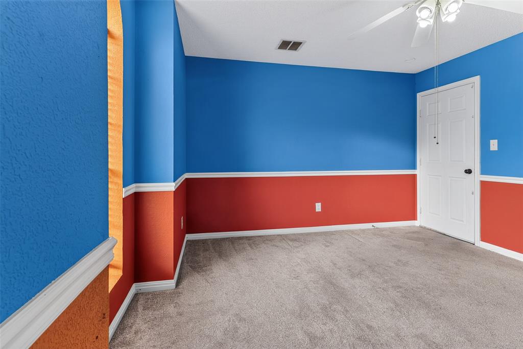 124 Topaz Circle Hewitt, TX 76643 - Photo 25 of 35 Carpeted room featuring a ceiling fan, crown molding, chair rail molding, and a paneled door with black hardware