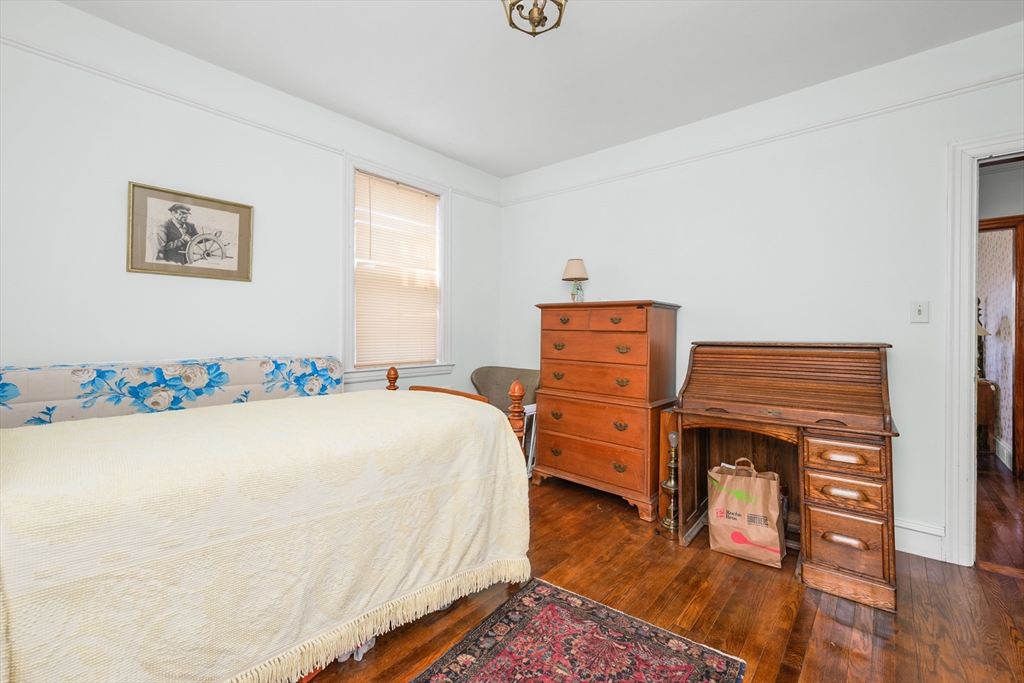 65 Louis Street Barnstable, MA 02601 - Photo 21 of 37 a bedroom with a bed and wooden floor