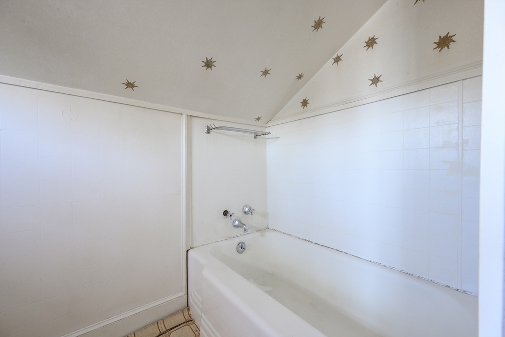 65 Louis Street Barnstable, MA 02601 - Photo 28 of 37 a bathroom with a white bath tub and a shower curtain